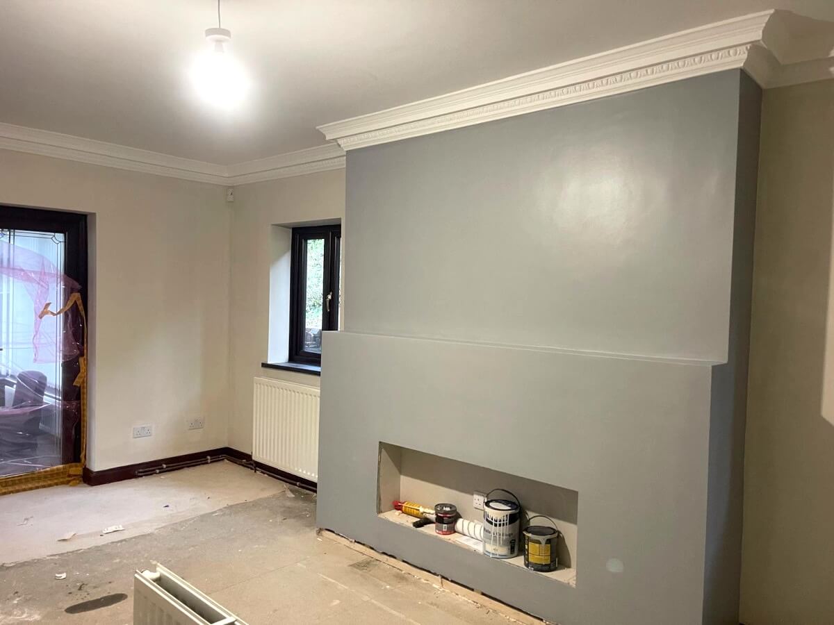 living-room-walls-feature-wall-painted-sunderland-foxglove-decor Room with a painted grey chimney breast and decorating tins on the floor