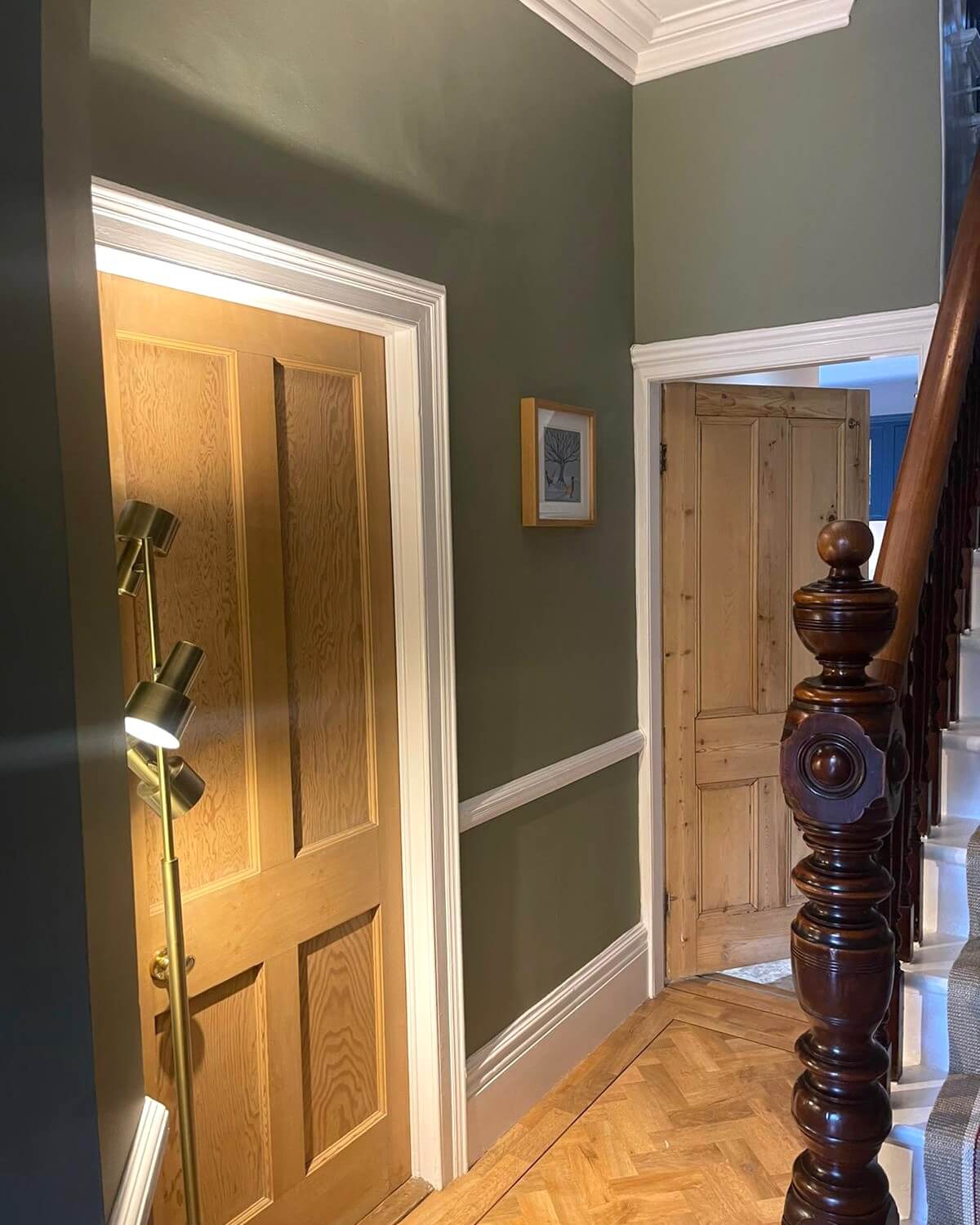 staircase-walls-painted-sunderland-foxglove-decor Hallway with grey-green walls, white skirting and a wooden panelled door